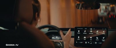 a woman driving a car at night with her hands on the steering wheel