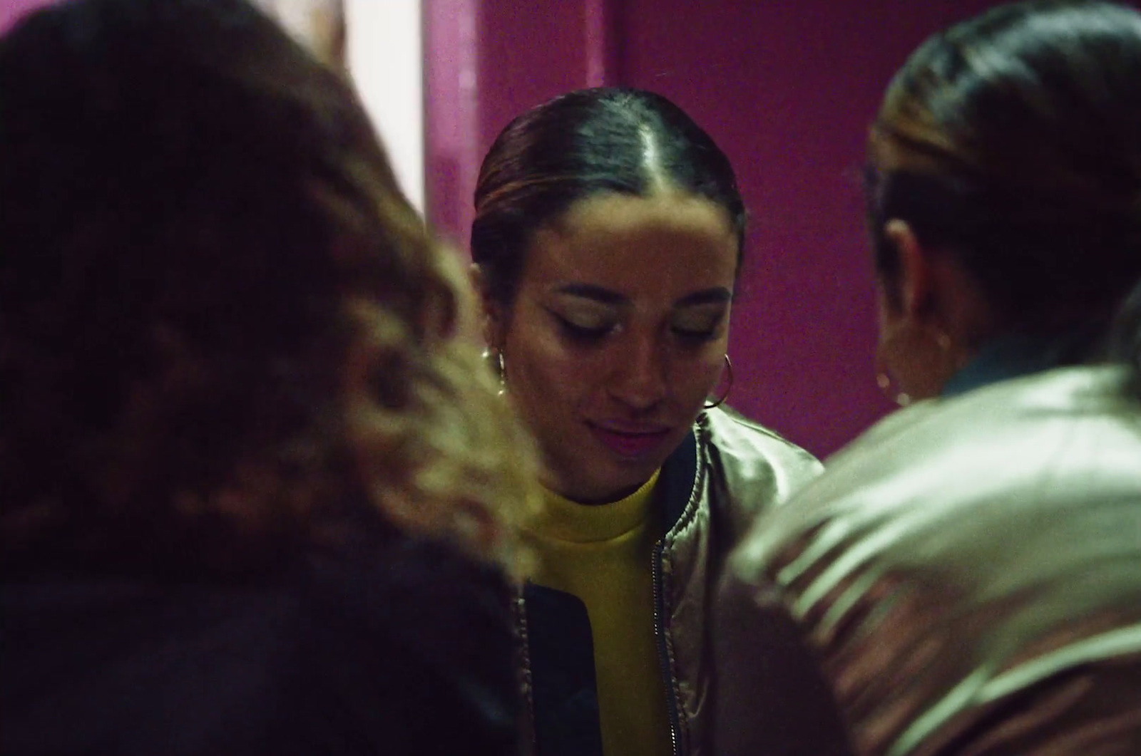 a group of women looking at each other in a room