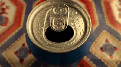 a can of soda sitting on top of a table