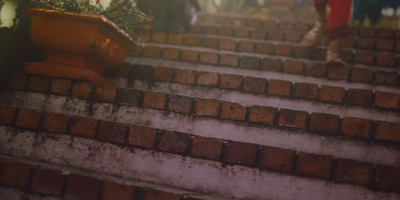 a woman is walking down a set of stairs