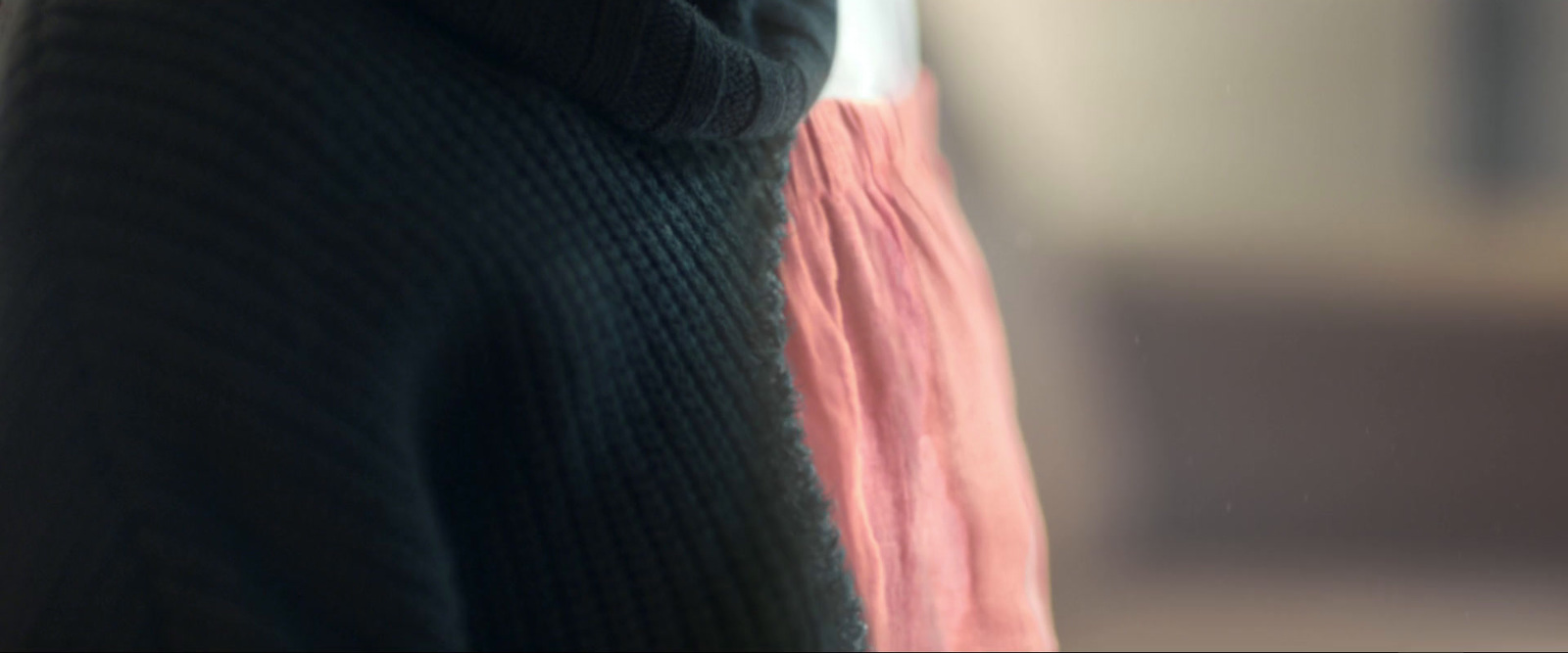 a close up of a person wearing a sweater