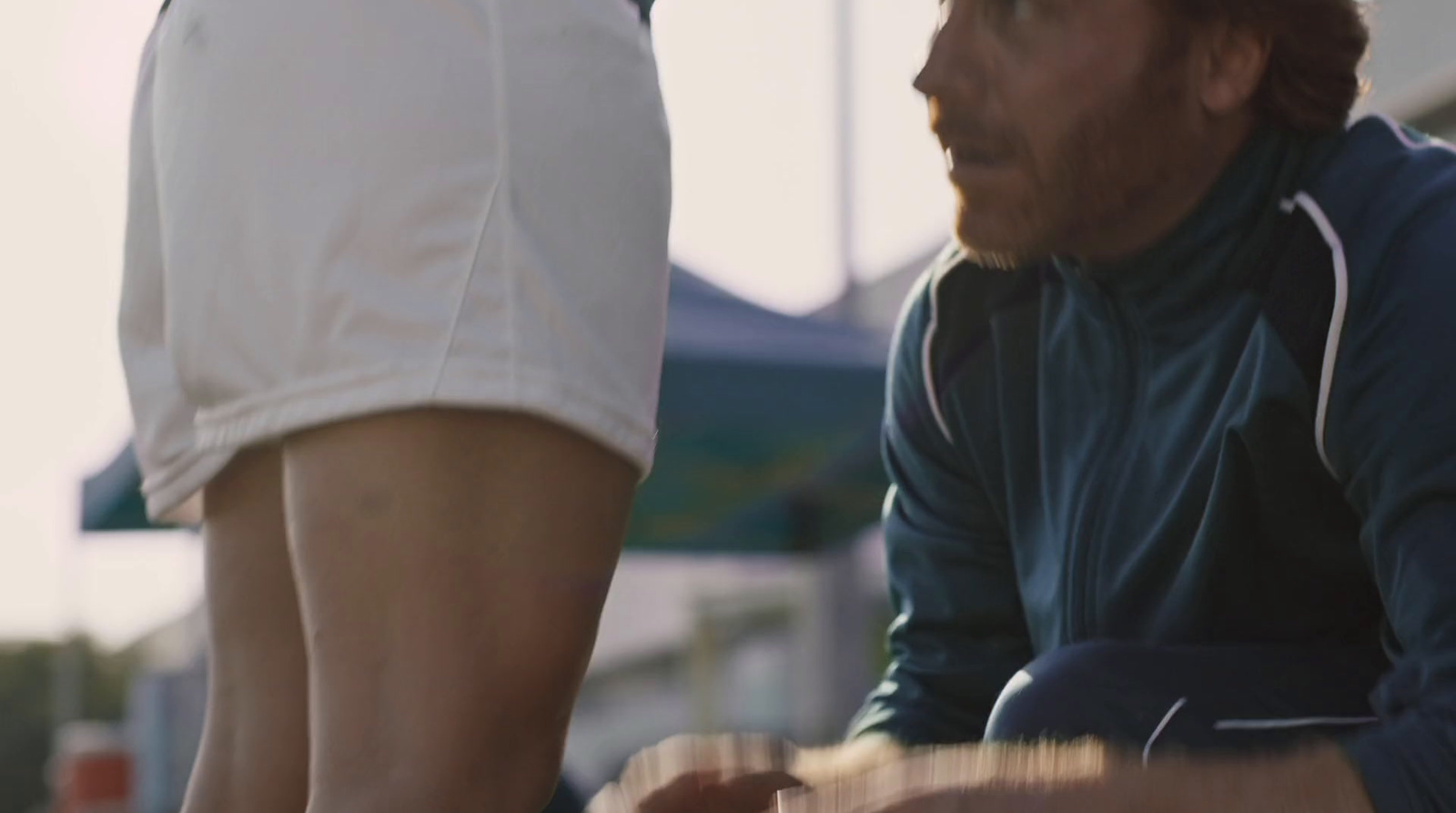 a close up of a person sitting on a skateboard