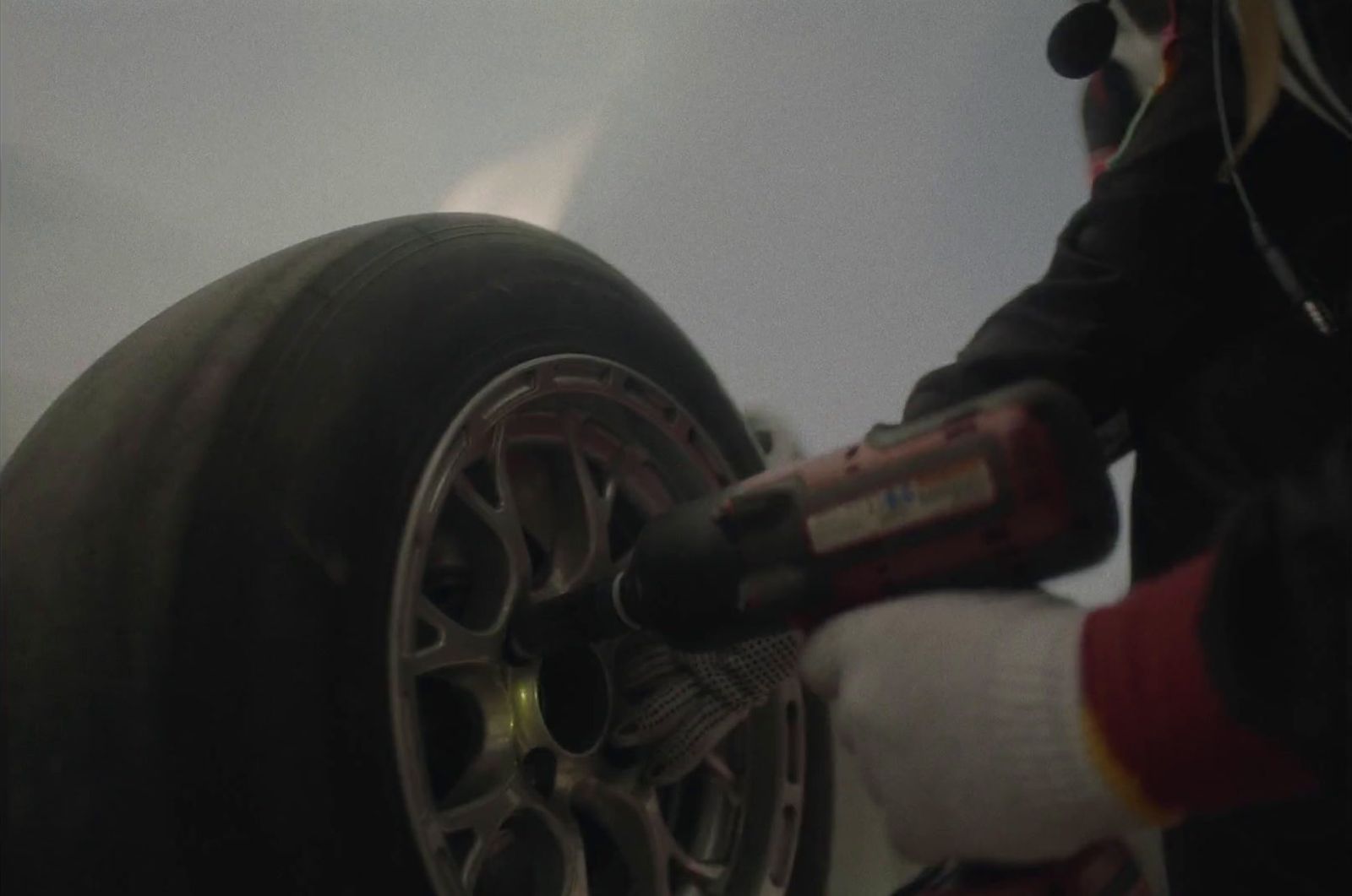 a person changing a tire on a car