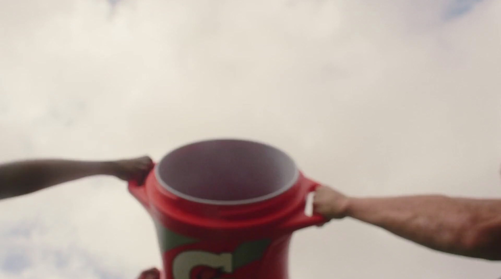 a person holding a red and green fire hydrant