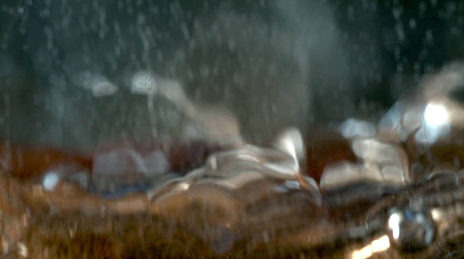 a blurry photo of a person laying down in the rain