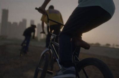 a group of people riding bikes down a dirt road