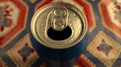 a can of soda sitting on top of a table