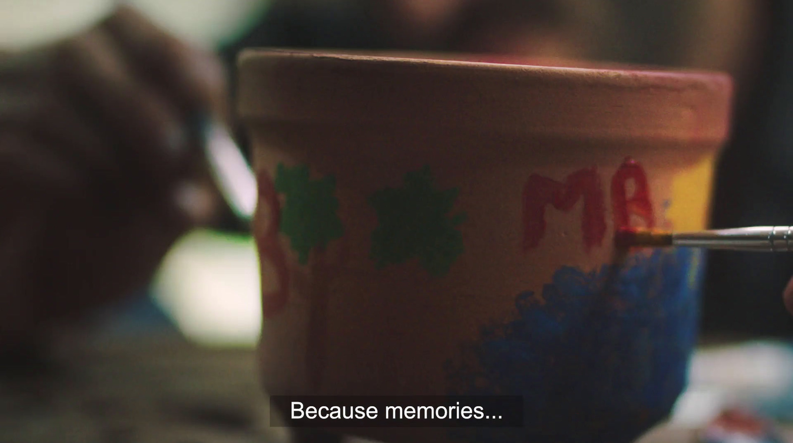 a person writing on a coffee cup with a pen