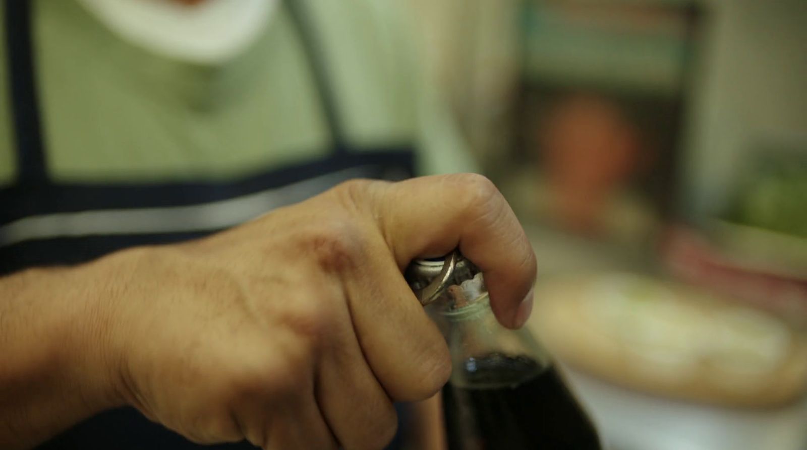 a close up of a person opening a bottle of wine