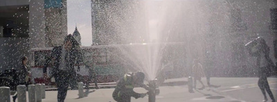 a man is spraying water from a fire hydrant