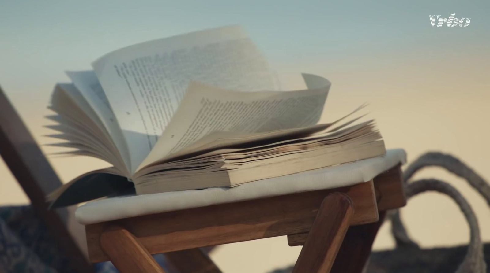 a stack of books sitting on top of a wooden chair