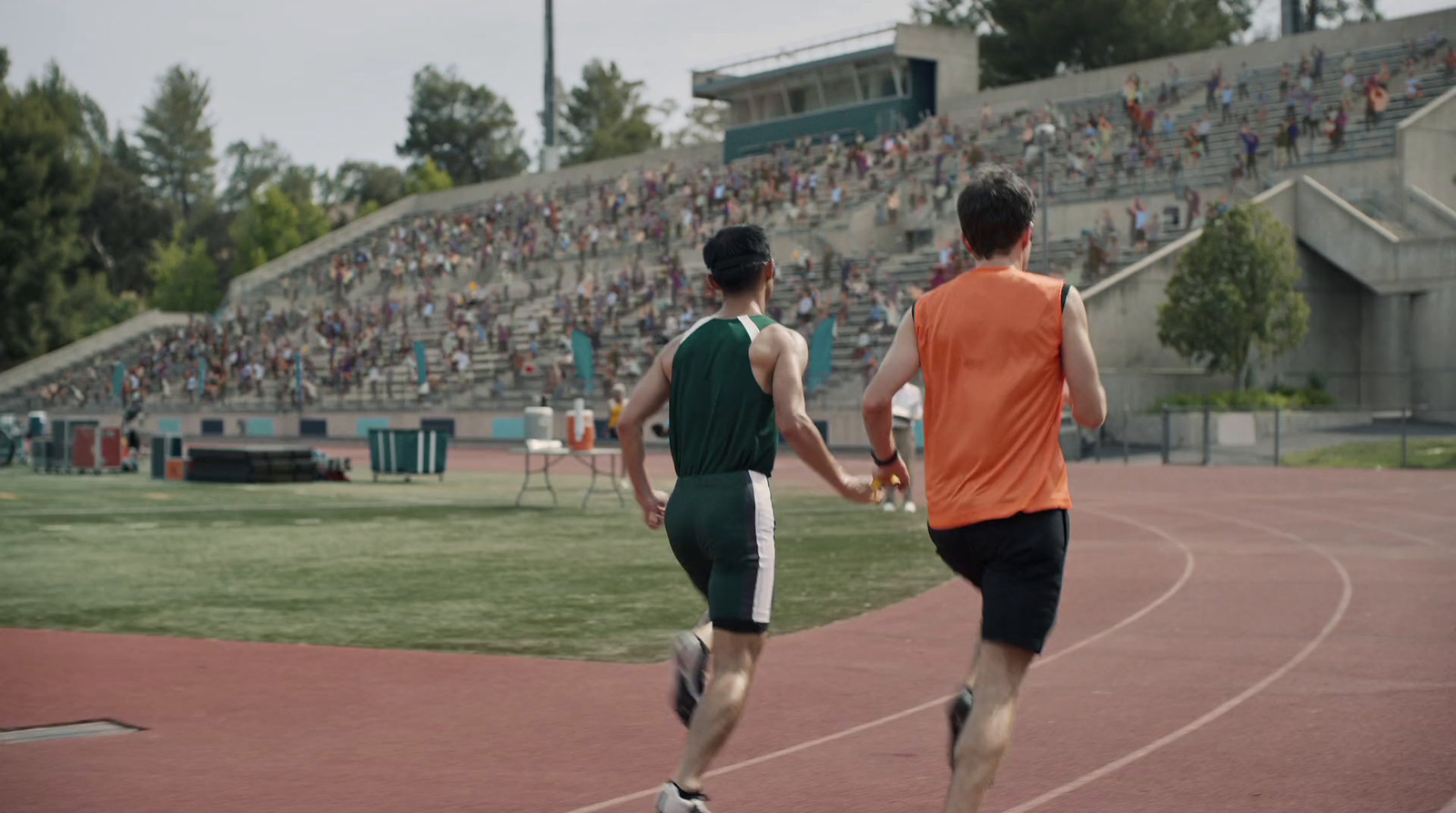 a couple of men standing on top of a track