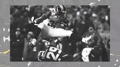 a black and white photo of a football player jumping in the air