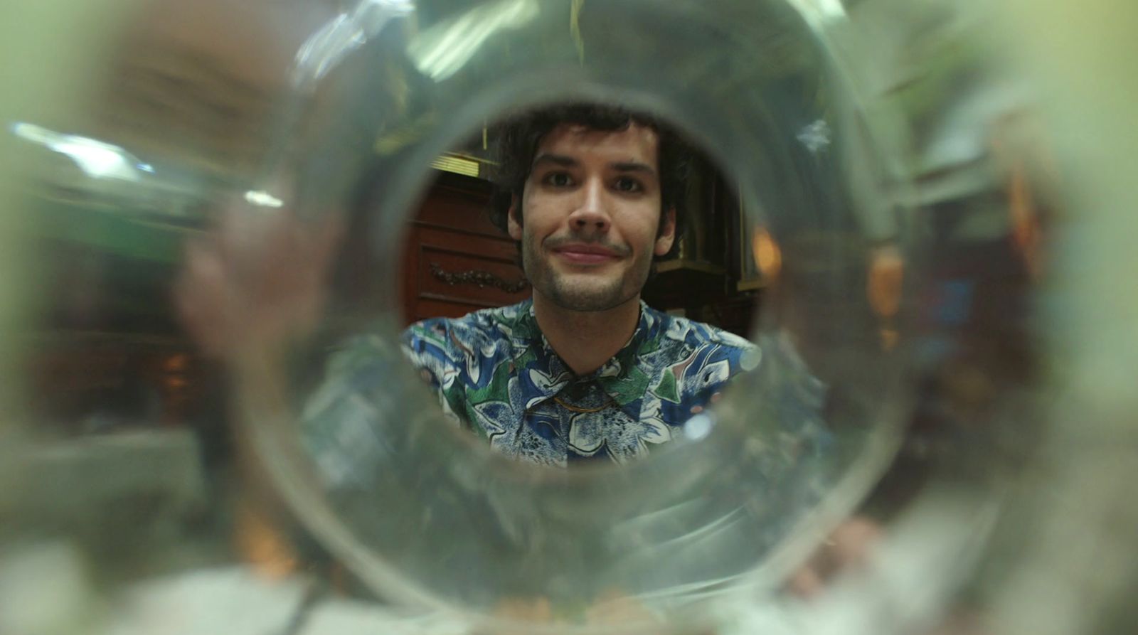 a man taking a picture of himself through a glass