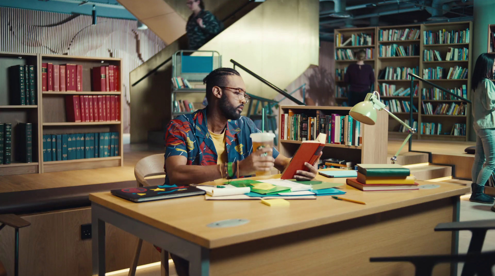 a man sitting at a desk in a library