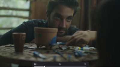 a man sitting at a table with a cup of coffee