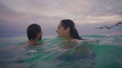 a man and a woman swimming in the ocean