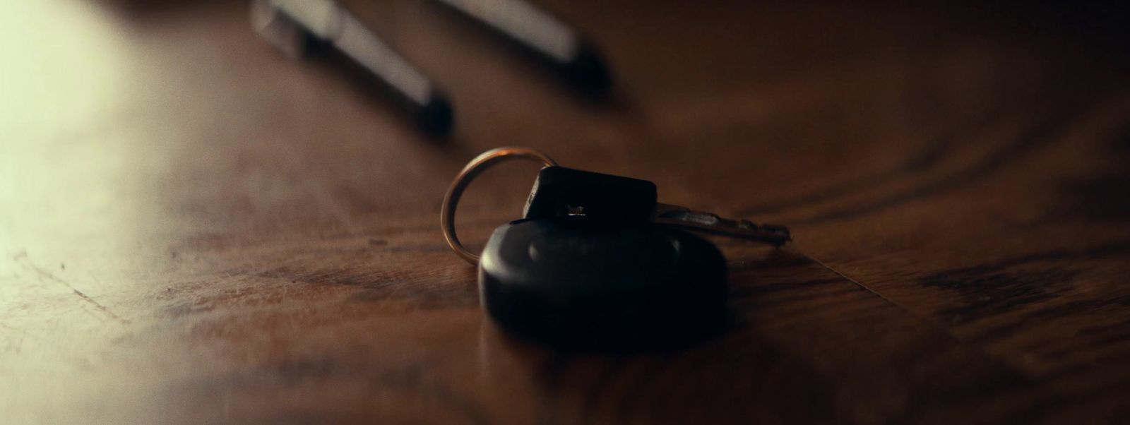 a keychain on a table next to a pair of scissors