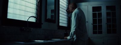 a man standing in front of a sink in a bathroom