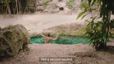 a man standing in front of a pool of water