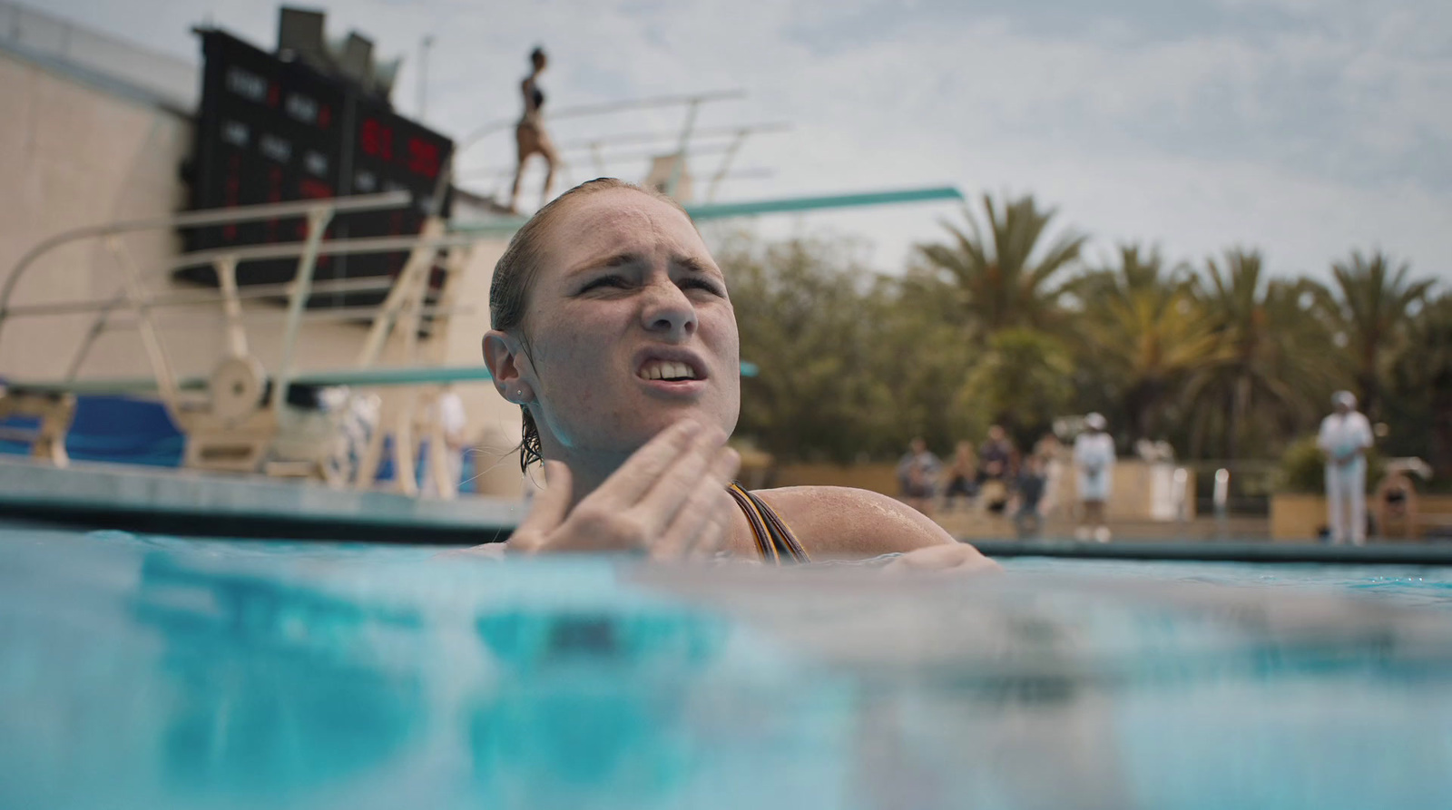 a woman swimming in a pool next to a boat