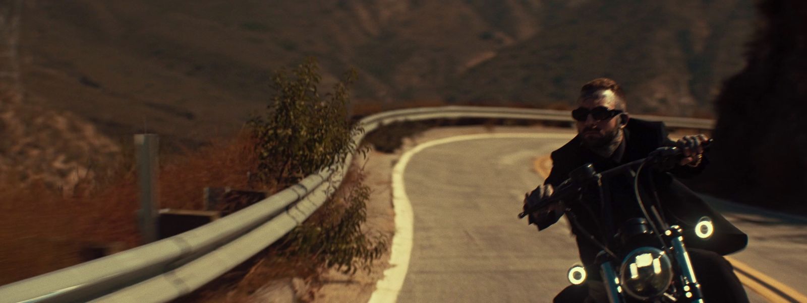 a man riding a motorcycle down a curvy road