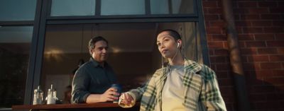 a man standing next to a woman in front of a window