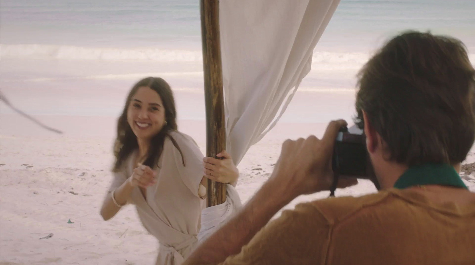 a woman is taking a picture of herself on the beach