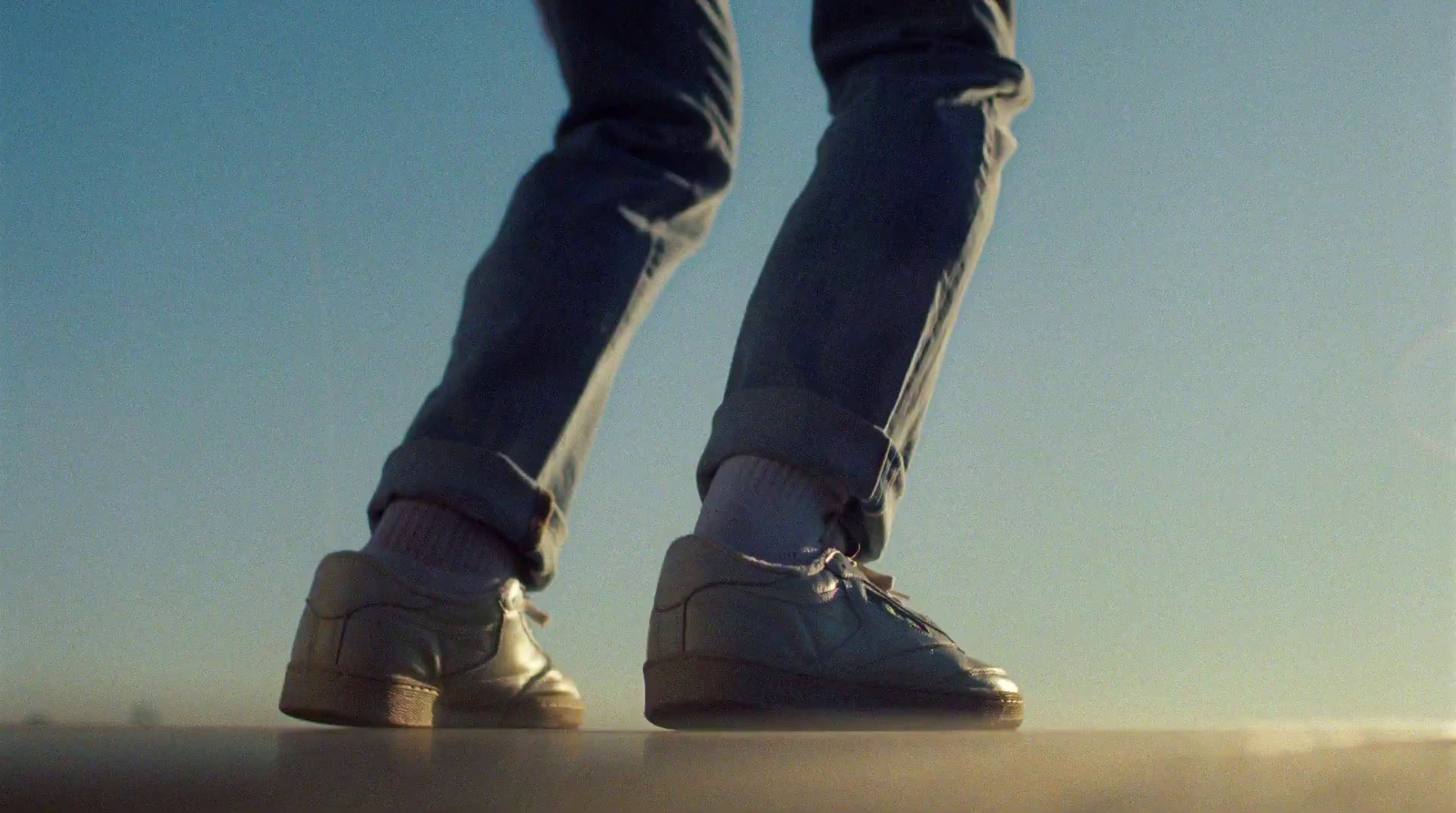 a person standing on a ledge with their feet up