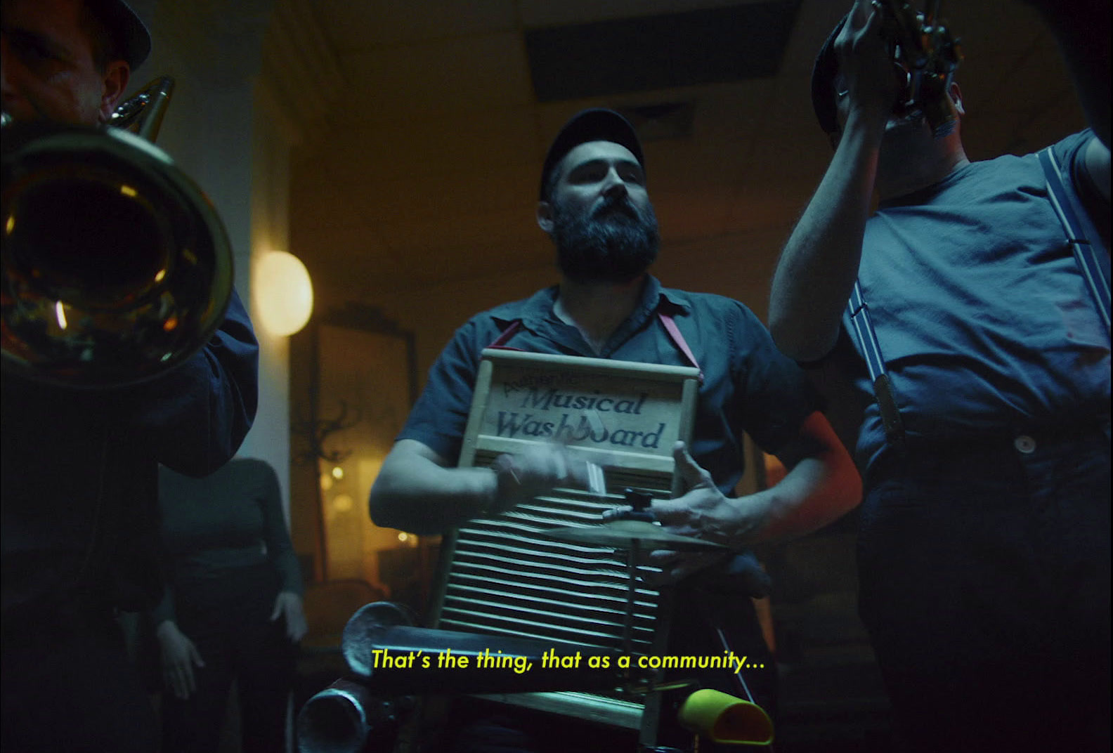 a man is playing an accordion in a dark room