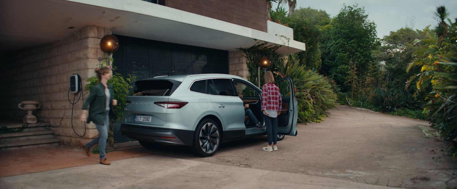 a couple of people standing next to a car