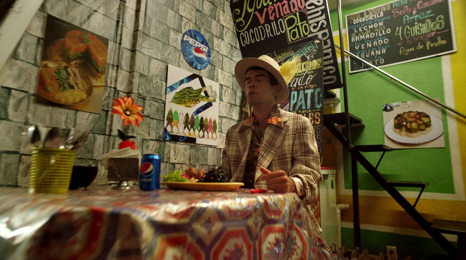 a man sitting at a table with a plate of food