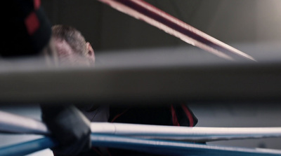 a man holding a baseball bat in a batting cage