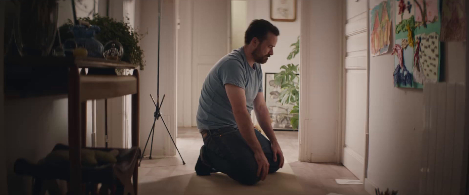 a man sitting on the floor in a hallway