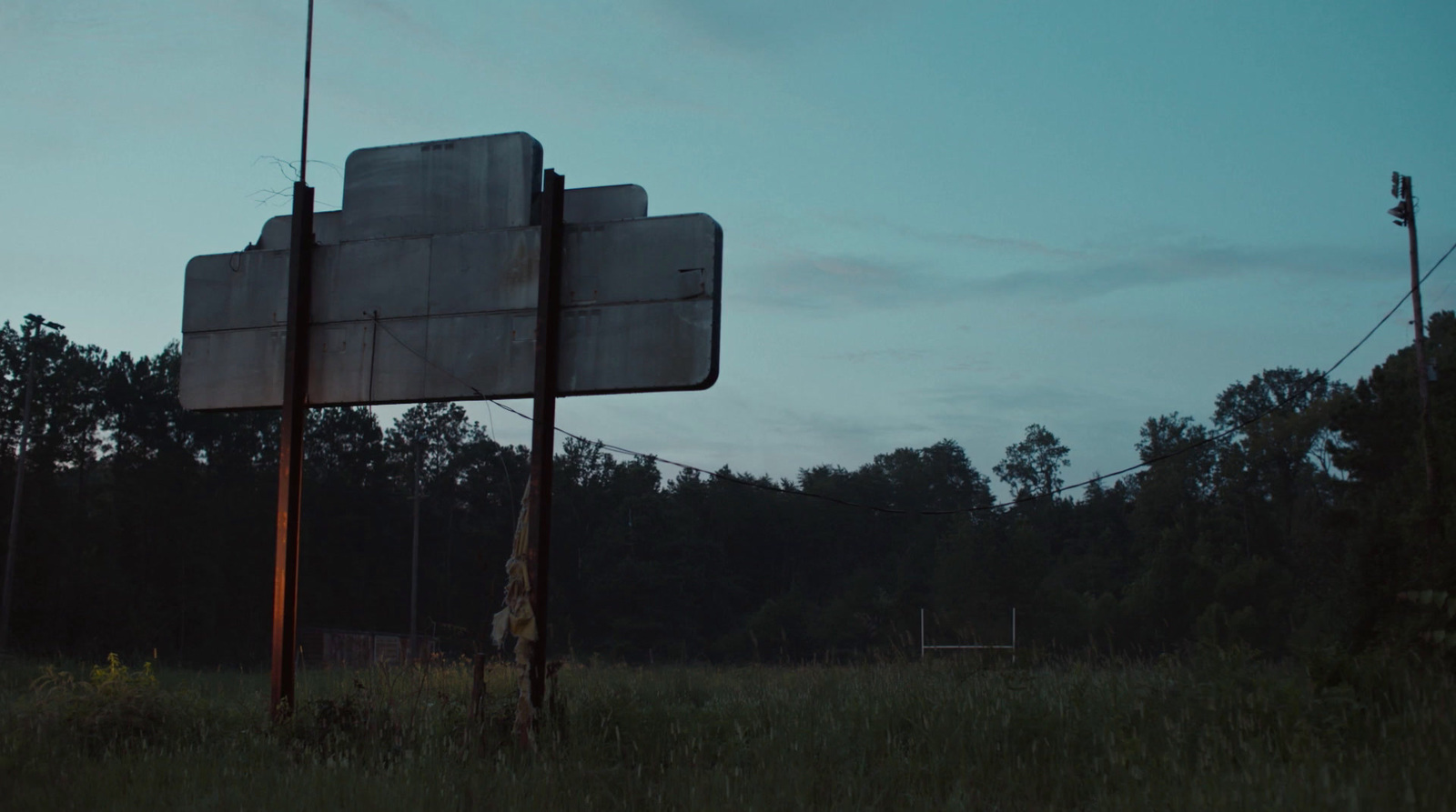 a street sign sitting in the middle of a field