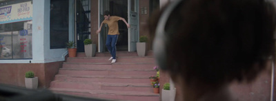 a woman is walking down the steps of a building