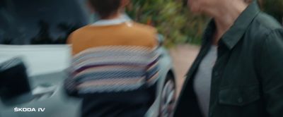 a blurry image of a man walking next to a woman