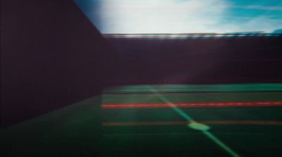 a blurry photo of a tennis court with a sky background