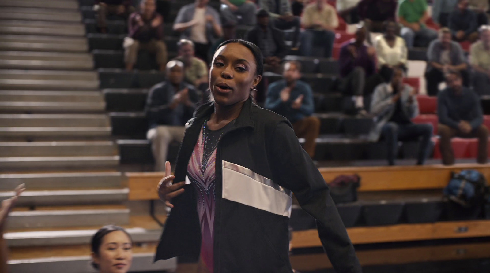 a woman standing in front of a crowd of people