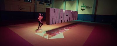 a woman standing in front of a large sign