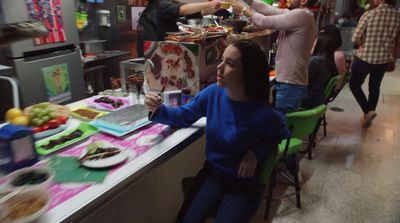 a woman sitting at a table in a restaurant