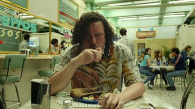 a man sitting at a table eating food