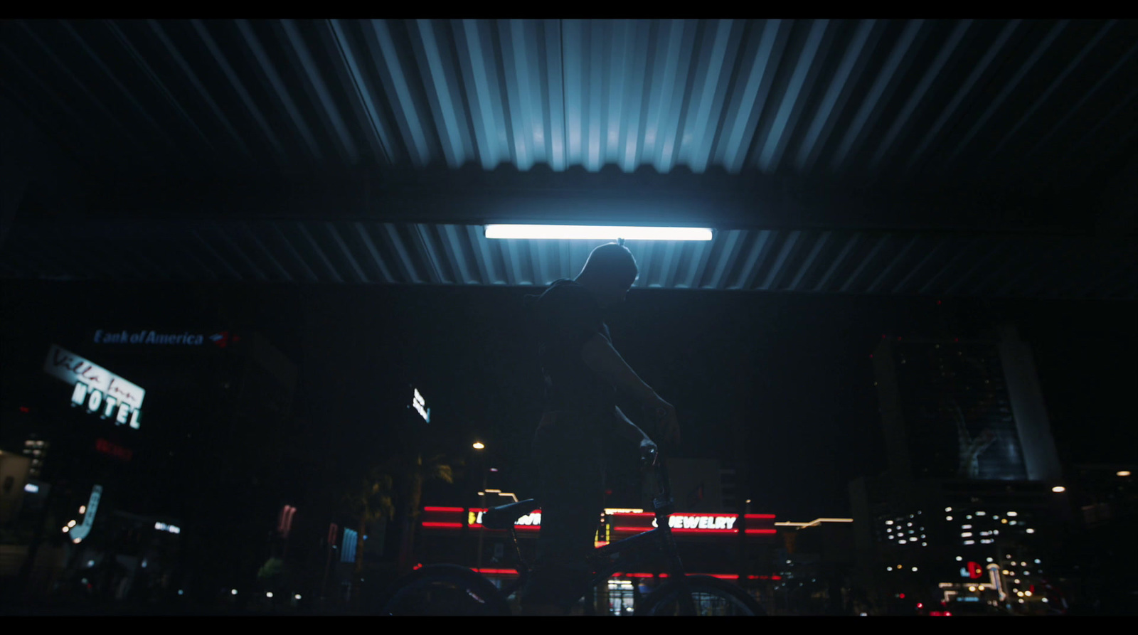 a person standing in a dark room with a light on