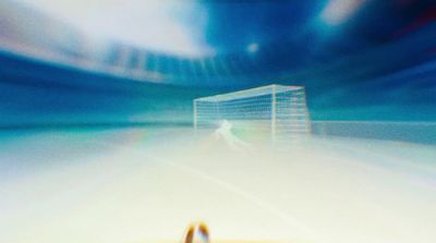 a blurry photo of a soccer goal and a soccer ball