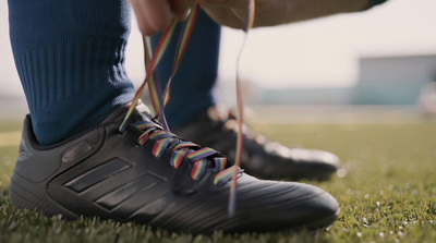 a close up of a person tying a shoelace