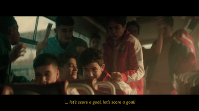 a group of boys are sitting on a bus
