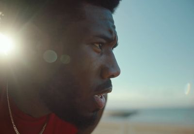 a close up of a person wearing a red shirt