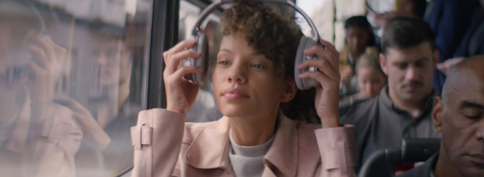 a woman sitting on a bus talking on a cell phone