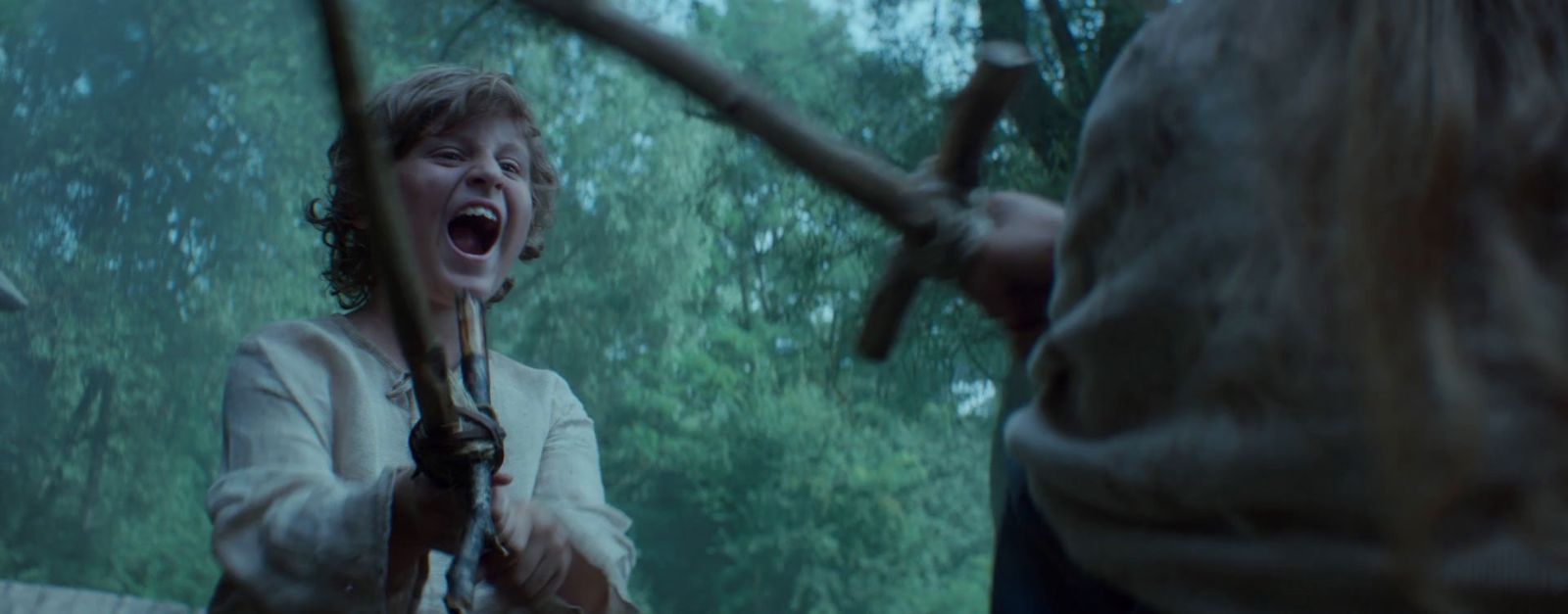 a woman holding a baseball bat in a forest