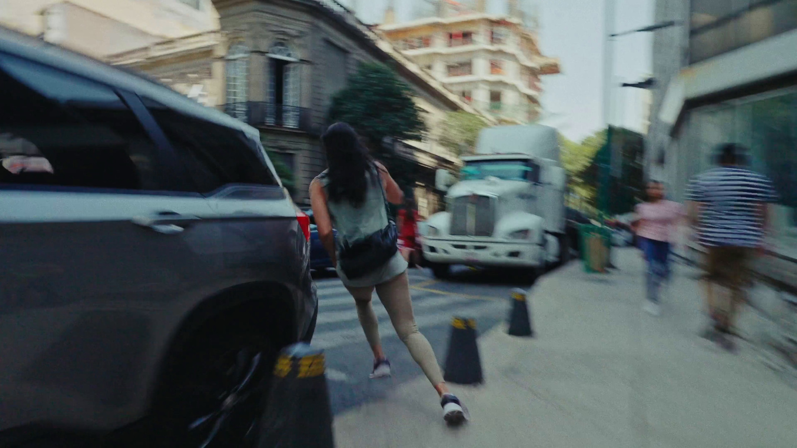 a woman is skateboarding down a busy street